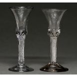 Two English wine glasses, c1760, the waisted bell bowl on multiple spiral air twist stem and conical