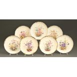 A set of seven Crown Derby dessert plates, 1884, painted with wild flowers on a primrose ground,