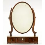 A George III mahogany dressing mirror, with oval plate and bow fronted base, 41.5cm l Replacement