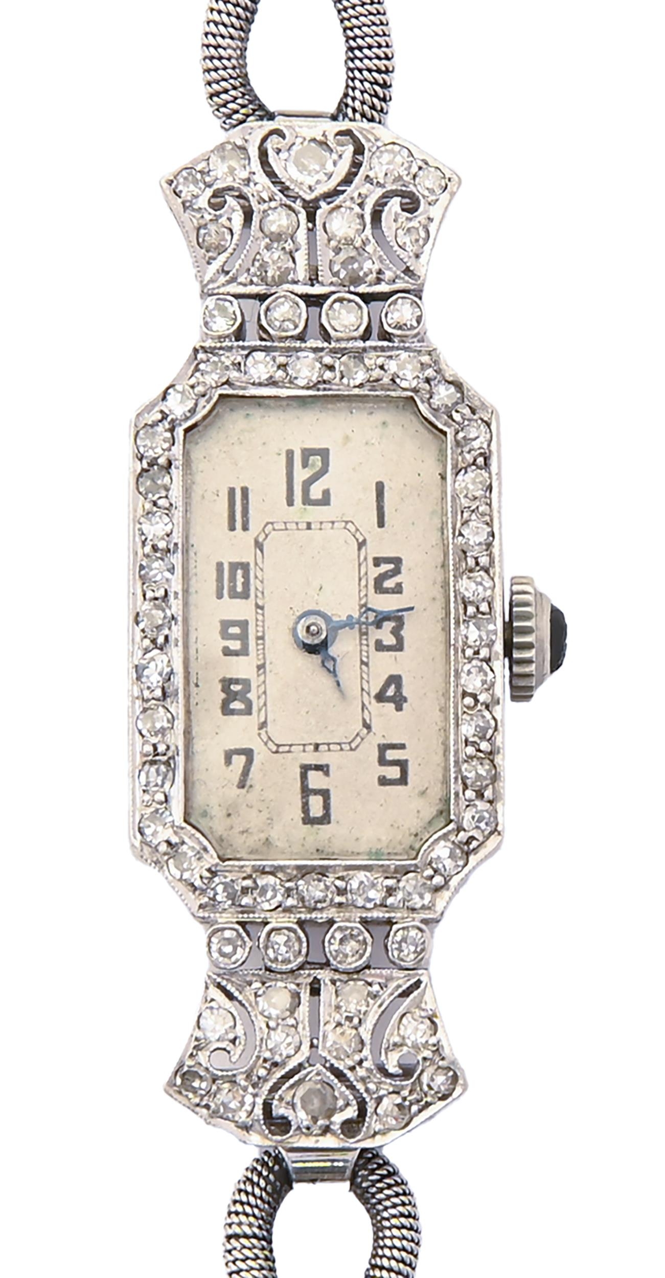 A diamond cocktail watch, c1930, pave set, the lugs articulated, in platinum, 14 x 40mm, on looped
