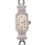 A diamond cocktail watch, c1930, pave set, the lugs articulated, in platinum, 14 x 40mm, on looped