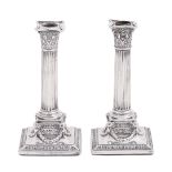 A pair of Victorian silver dwarf columnar candlesticks, 18cm h, by Nathan & Hayes, London 1892,