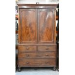 A Victorian mahogany linen press, the upper part fitted with trays enclosed by a pair of doors