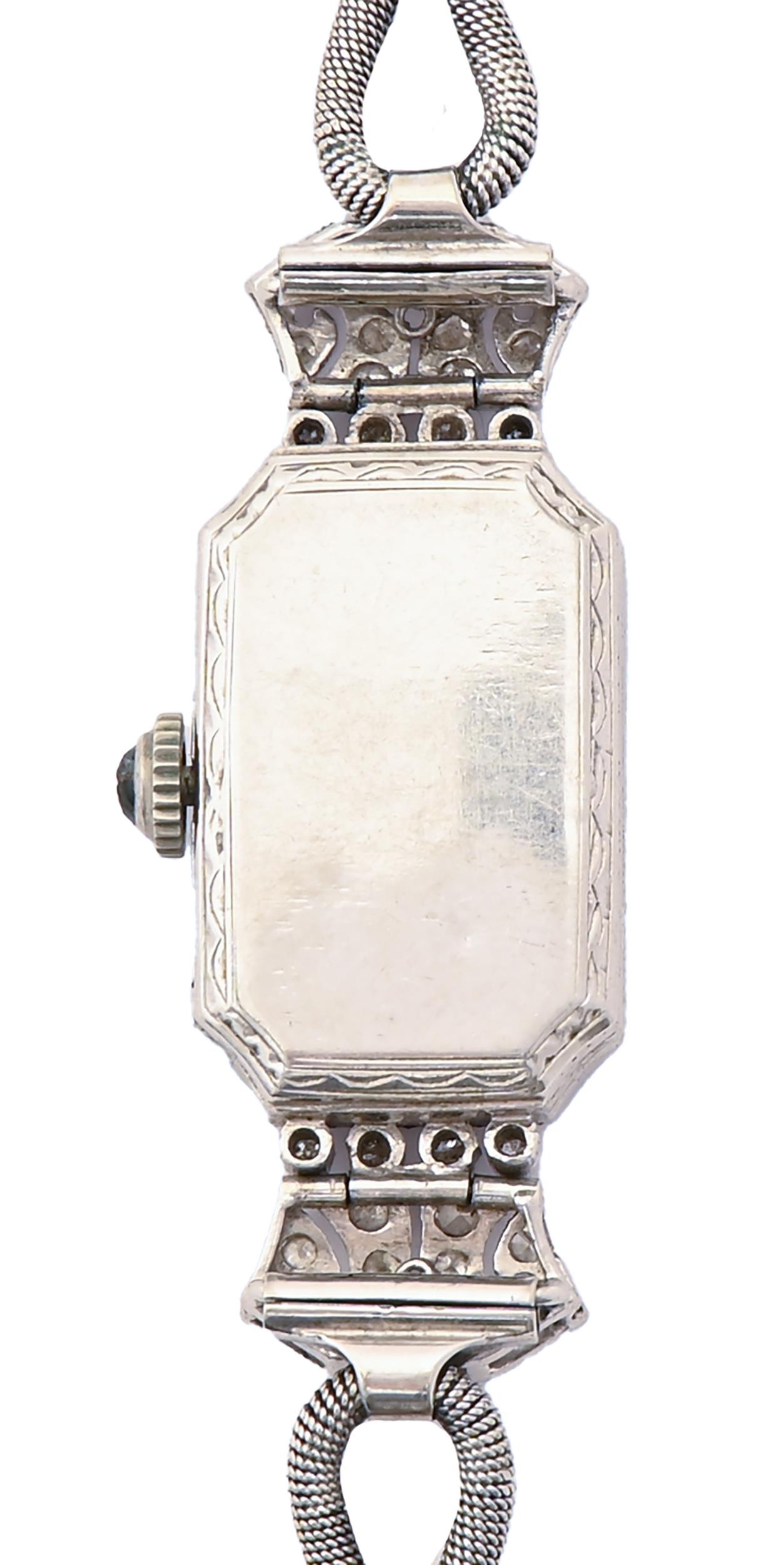 A diamond cocktail watch, c1930, pave set, the lugs articulated, in platinum, 14 x 40mm, on looped - Image 2 of 2