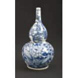 A Chinese blue and white double gourd vase, late 19th / early 20th c, painted with peafowl and