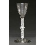 An English wine glass, c1770, the unusual ogee bowl on multiple spiral opaque twist stem with centre