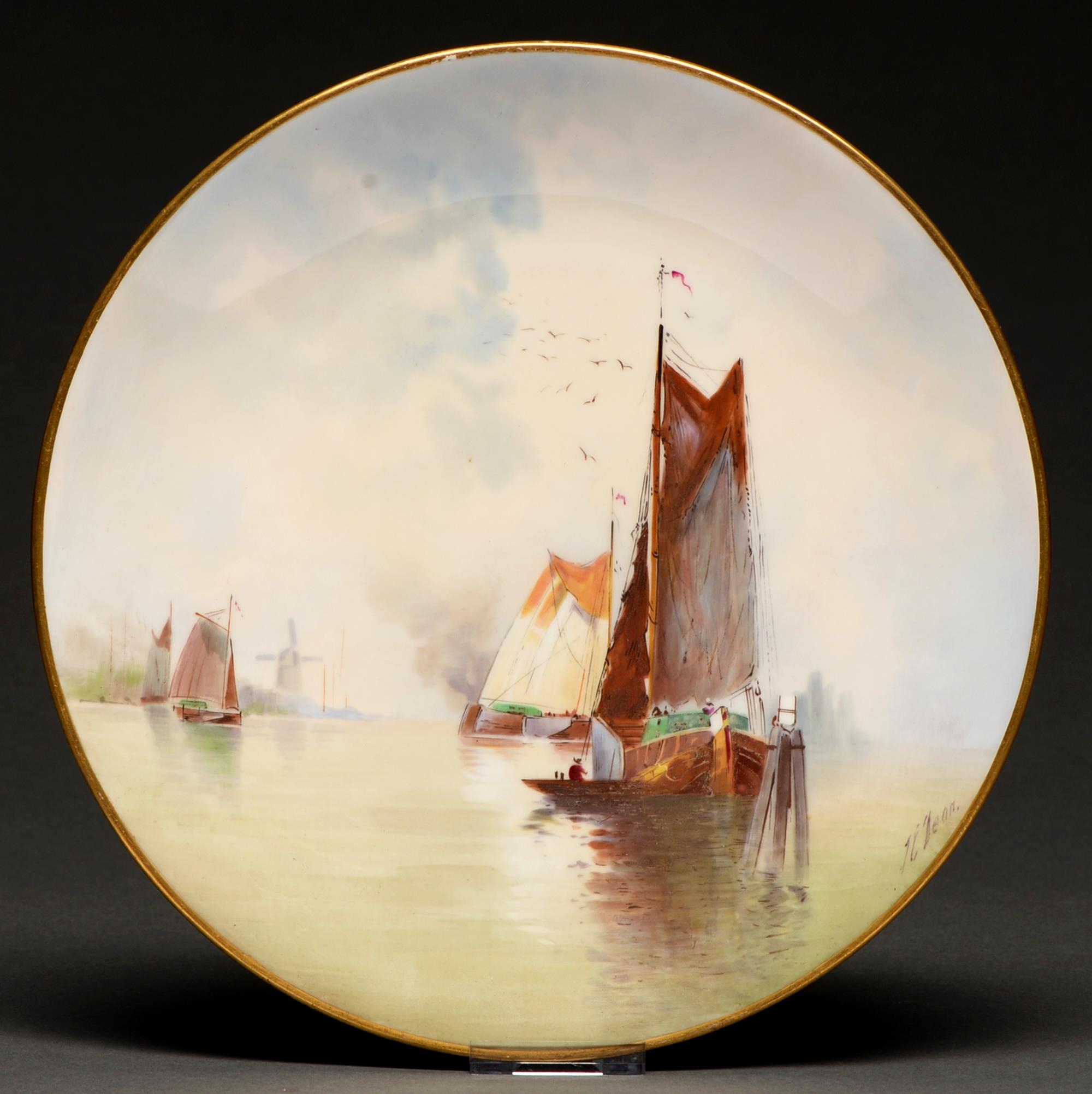 A Minton plate 1902, painted by J E Dean, signed, with Dutch fishing boats in an estuary, 24cm diam,