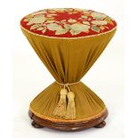 A Victorian fabric covered spool shaped stool, with Berlin woolwork top, turned rosewood base and
