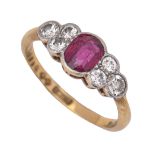 A ruby and diamond ring, the larger oval ruby flanked by clusters of three diamonds, gold hoop