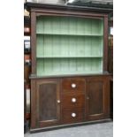 A grained pine dresser, early 20th c, the interior of the boarded rack painted green, white