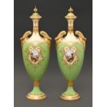 A pair of Coalport vases and covers, c1910, of shield shape, painted with highland landscapes in