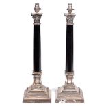 A pair of EPNS mounted black marble columnar table lamps, 20th / 21st c, on stepped square foot,