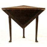 A carved and dark-stained oak single dropleaf table, elements 18th c, on three turned legs and pad