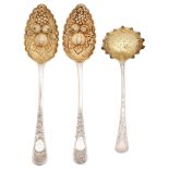 A pair of George III silver tablespoons and a sauce ladle, later chased and gilt as berry spoons,