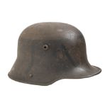A WWII German steel helmet, traces of black paint, the leather partial lining inscribed on the