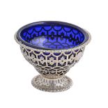 A George III silver sugar bowl, of pierced and engraved ogee shape, blue glass liner, 10cm h, by