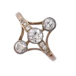 A diamond ring, early 20th c, with three old cut diamond collets, gold hoop marked 18ct, 2.5g,