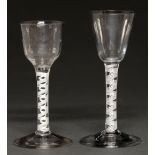 Two English wine glasses, c1770-80, the fluted ogee or round funnel bowl on double series opaque