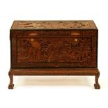 A Chinese carved camphor wood chest on stand, c1930s, with claw and ball feet, 73cm h; 104 x 52cm