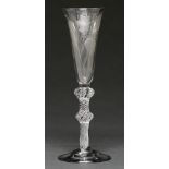 An English ale glass, c1750-60, the round funnel bowl engraved with hops and barley, on multiple
