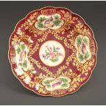 A Worcester dessert dish, the porcelain c1775-80, the decoration later, painted with panels of birds