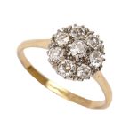 A diamond cluster ring, gold hoop marked 18ct, 2.7g, size L Good condition