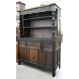 A carved and partly ebonised oak sideboard, early 20th c, the lower part with shield of arms flanked