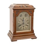 A German oak mantel clock, early 20th c, with silvered dial and Gustav Becker three train movement