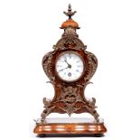 A French walnut mantel clock, late 19th c, in Louis XV style, with brass mounts and enamel dial,