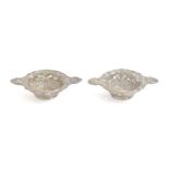 A pair of Victorian die stamped silver sweetmeat dishes, 10.7cm over handles, maker's mark rubbed,