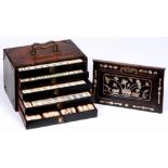A Chinese mahjong set in mother of pearl inlaid hardwood chest, early 20th c, with bone and bamboo