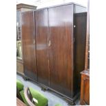 A mahogany three door wardrobe, early 20th c, on ogee feet, 187cm h; 157cm l Moulding between the