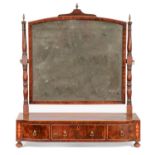 A George IV mahogany and line inlaid dressing mirror, the arched frame between ring turned