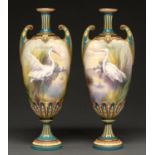 A pair of Hadley's Worcester vases, 1902-1905, painted with egrets in a watery landscape with yellow