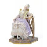 A Meissen figure of a maiden asleep in a chair, late 19th/early 20th c, in lace trimmed striped