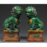 A pair of Chinese Tile Works style models of dogs of Fo, 20th c,  24cm h ` One or two small glaze