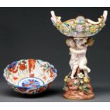 A John Bevington floral encrusted fruit stand, 1872-1892, with pierced bowl and embracing boy and
