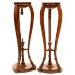 A pair of neo classical style carved mahogany torcheres, second quarter 20th c, with guilloche and
