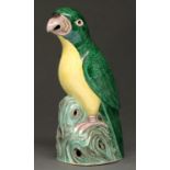 A Chinese  glazed biscuit model of a green parrot, first half 20th c,  with unglazed eye,
