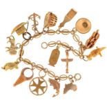 A gold charm bracelet with various English and foreign gold charms, 18cm l, bracelet marked 14K, the