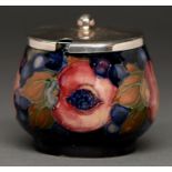 A Moorcroft Pomegranate preserve pot, c1920, 68mm h, impressed marks and a metal cover (2) Good