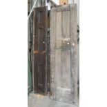 A Victorian pine panelled door,  another and two lengths of stained wood panelling, various sizes