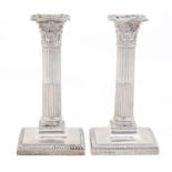A pair of Edwardian silver column candlesticks, with gadrooned foot, nozzles, 21cm h, by Josiah