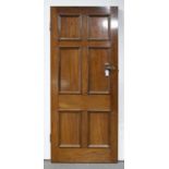 An Edwardian  mahogany  six panel door with contemporary brass mortice lock, oval knobs and