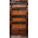 A mahogany sectional bookcase, early 20th c, in four graduated sections, each with glazed up-and-