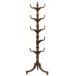 A George IV mahogany hat stand, c1830, the turned shaft with vase knops and acorn finial, on tripod,