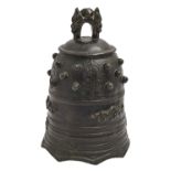A Japanese bronze bell, cast with kiku, uneven rich black patina, 19cm h