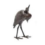 A Japanese bronze sculpture of an  egret, Meiji period,  with gold eye, even brown patina, 26cm h