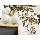 A set of three cold-painted ceiling lights, late 20th c, flowering leafy branches, glass shades,