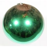 A green mirrored glass witches ball, late 19th/early 20th c, 24cm diam  Good condition, some wear